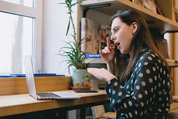 A professional lady attending a meeting online.