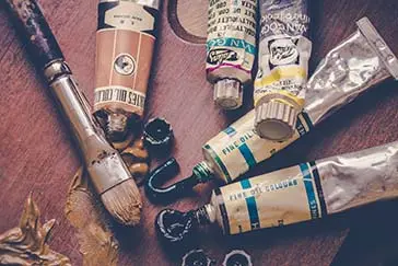 Colored paints with a paint brush.