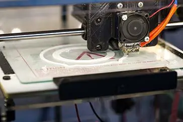 A machine printing on a cardboard.
